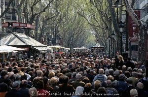 Crowds in La Rambla, an iconic and busy street in Barcelona, Spain.